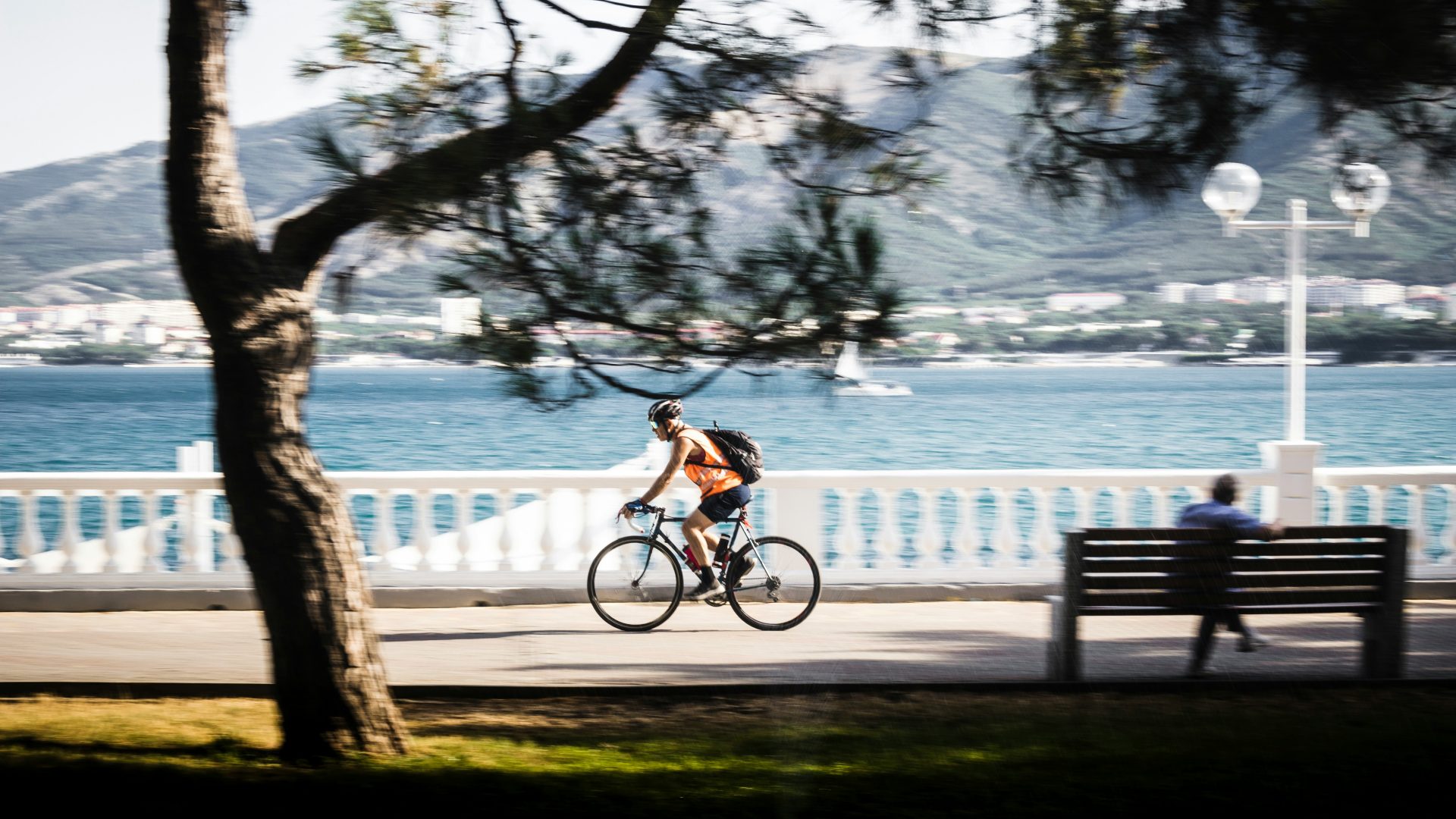 Man cycling along the waterfront promenade